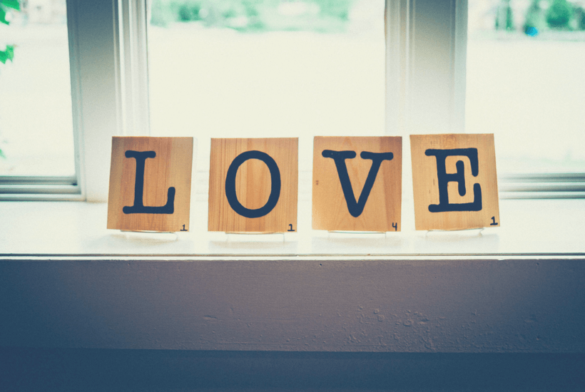 Why You Should Love Yourself First: Scrabble-like Letters L.O.V.E placed in front of a window